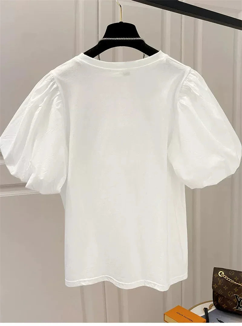 Camiseta mujer  Dulce moda.  cuello redondo y manga abultada.