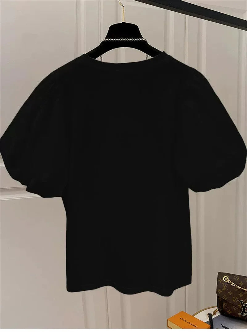 Camiseta mujer  Dulce moda.  cuello redondo y manga abultada.